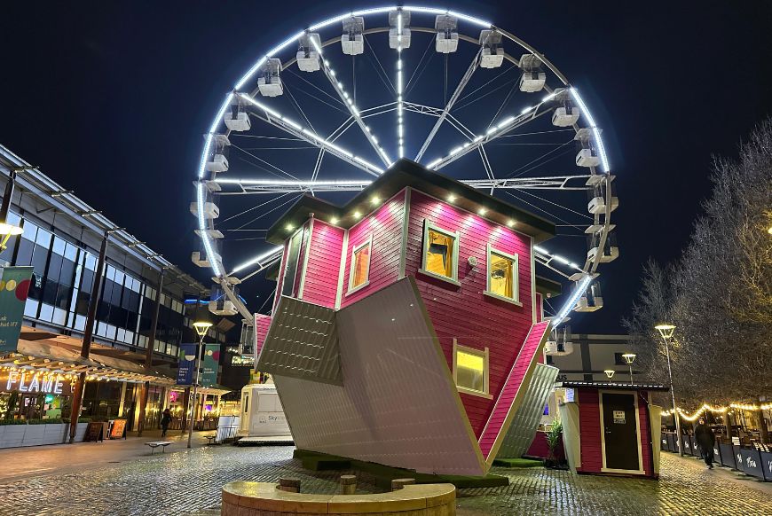 Upside down house at night